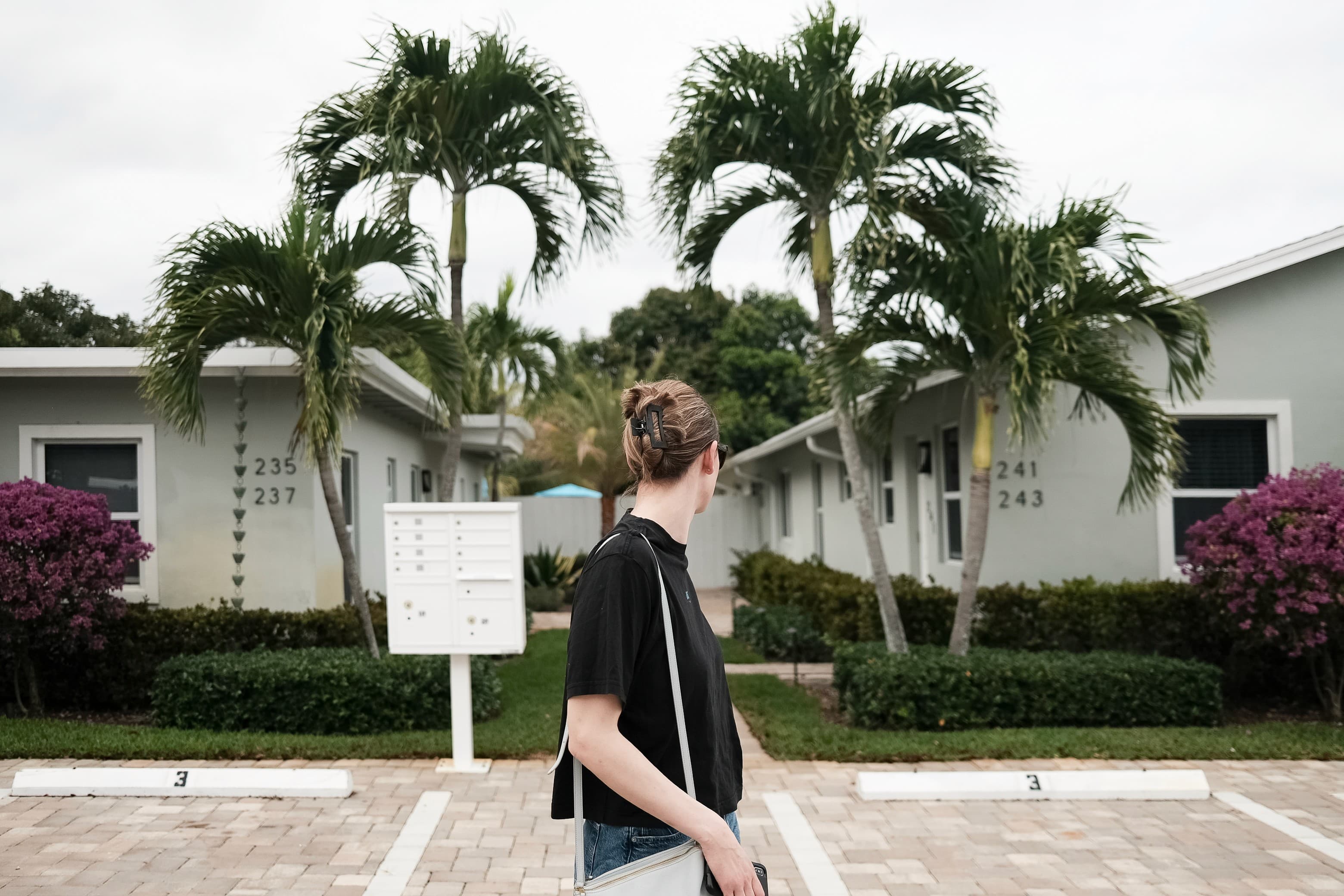 Amanda walking through a palm-lined neighborhood in Florida